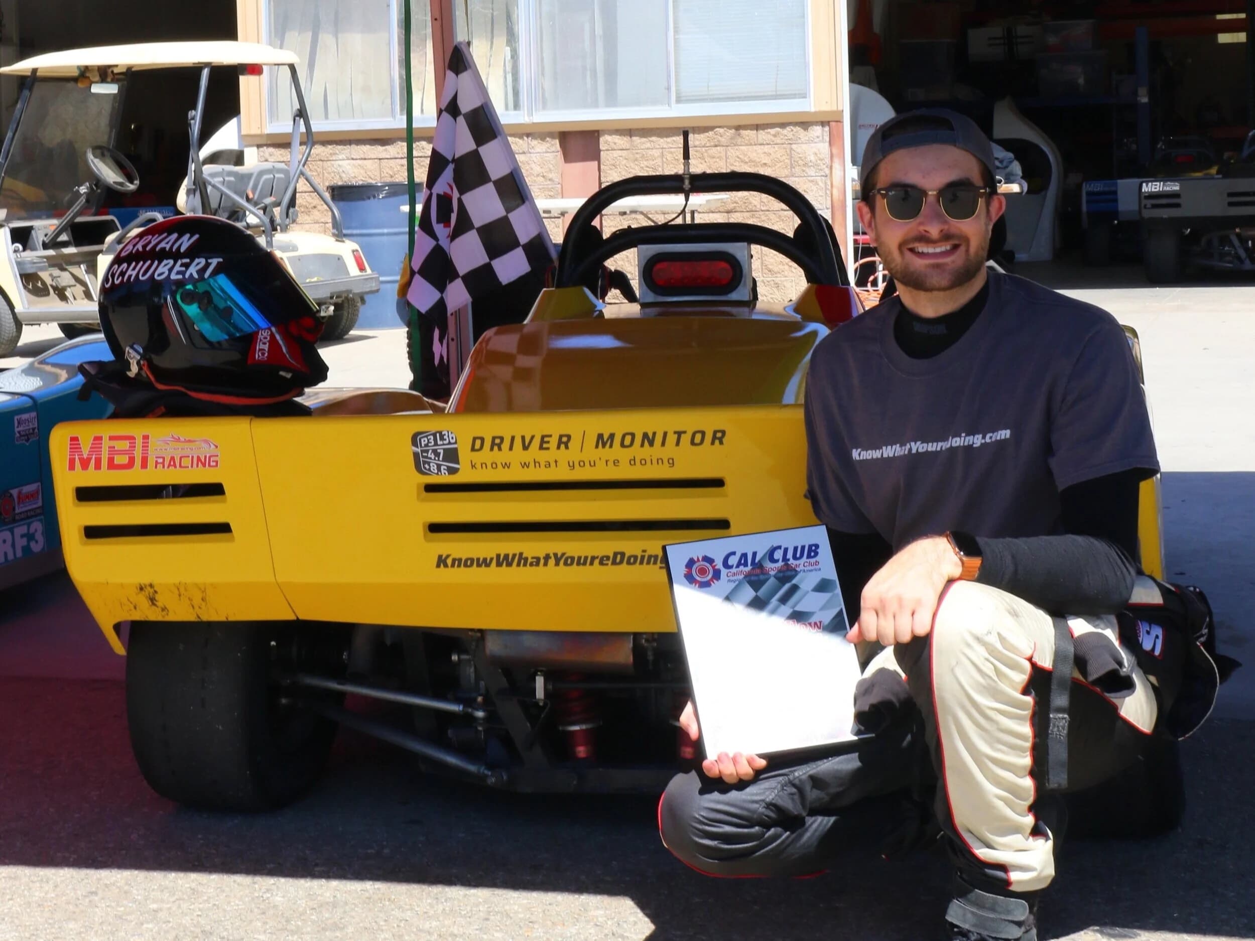Bryan Schubert in front of his car